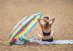 vrouw op het strand met parasol